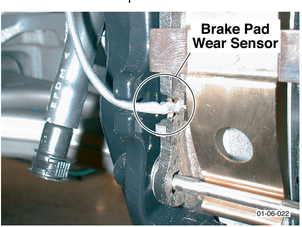 Close-up photo of the brake pad wear sensor connector