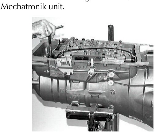 Photo showing the removal of the Mechatronik unit after screws have been removed