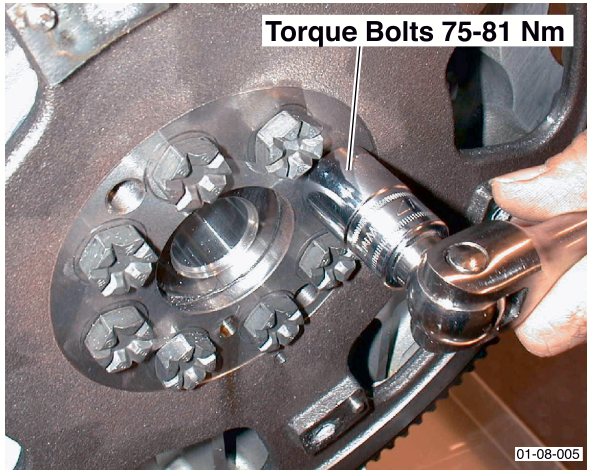 Torque wrench tightening flywheel mounting bolts with text 'Torque Bolts 75-81 Nm'