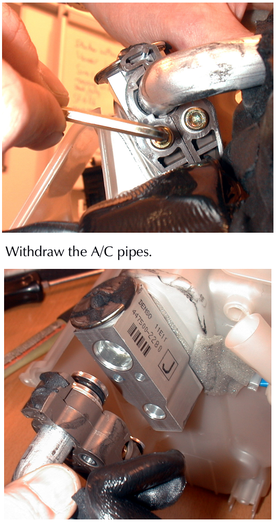 A close-up view of hands removing an A/C pipe clamp from the expansion valve assembly with a small tool.