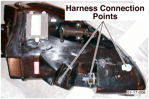 Photo of headlamp unit rear showing three wiring connectors with callout text Harness Connection Points