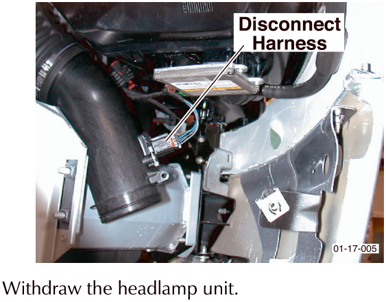 Photo of engine bay area showing wiring harness being disconnected with callout text Disconnect Harness