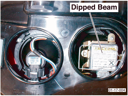Photo of headlight assembly rear showing two bulb sockets, one labeled Dipped Beam