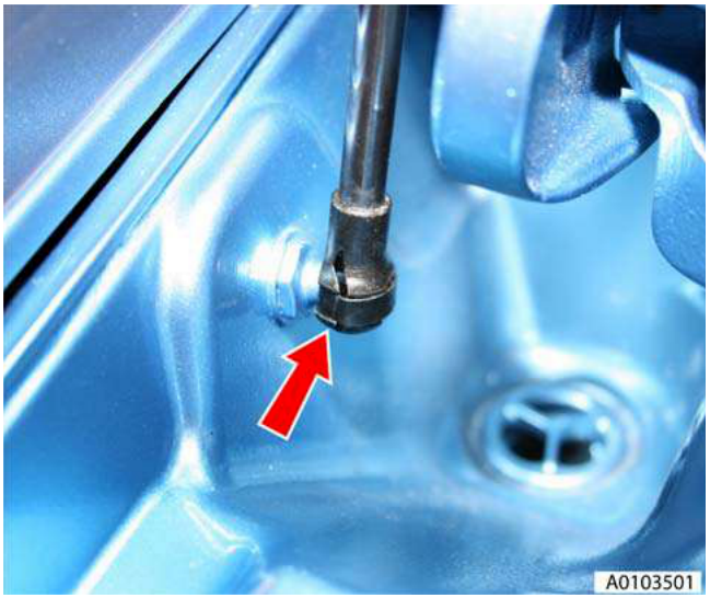 Close-up of a gas strut clip being released on the right-hand side, showing the mounting point and bolt hole.