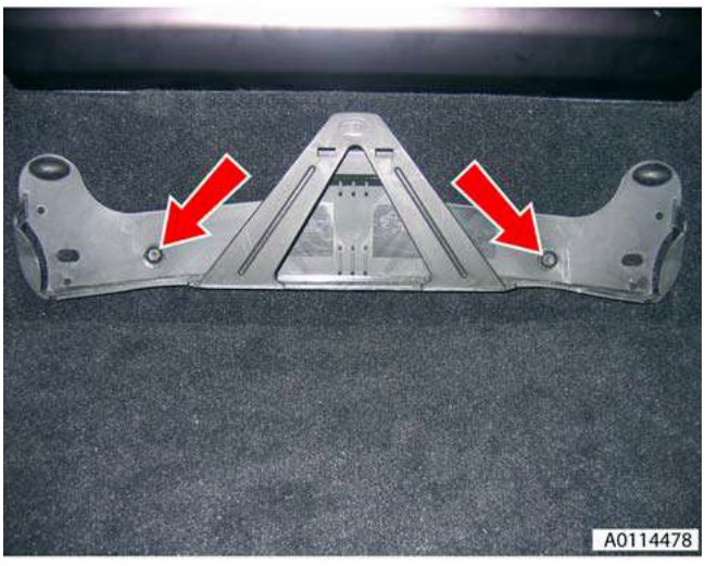 Warning triangle bracket removed, showing the two mounting bolt holes with red arrows pointing to them.