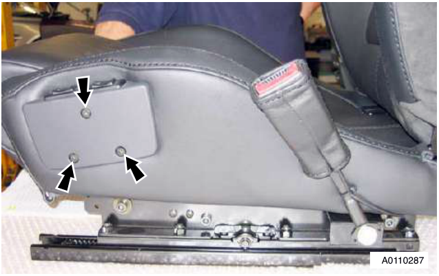 Close-up of seat showing three screws on the heater and lumbar switch assembly
