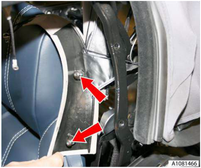 Close-up view of a hand removing bolts from the B-post trim near the roof mechanism