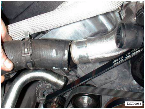 Top hose being disconnected from the engine body