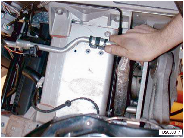 Hand removing LP pipe from body P-clips