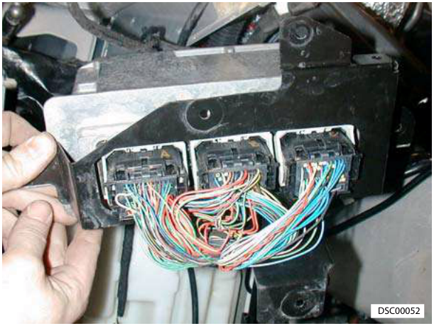 Hands disconnecting ECM multiplugs