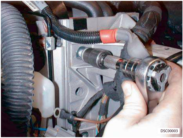 Photo showing a hand using a socket wrench to install a bolt on the subframe mounting point