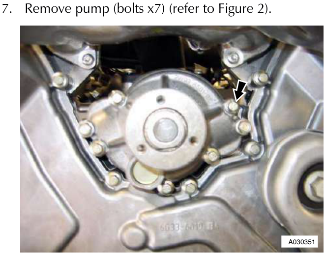 Close up view of the water pump assembly with seven bolts around its perimeter indicated by an arrow.