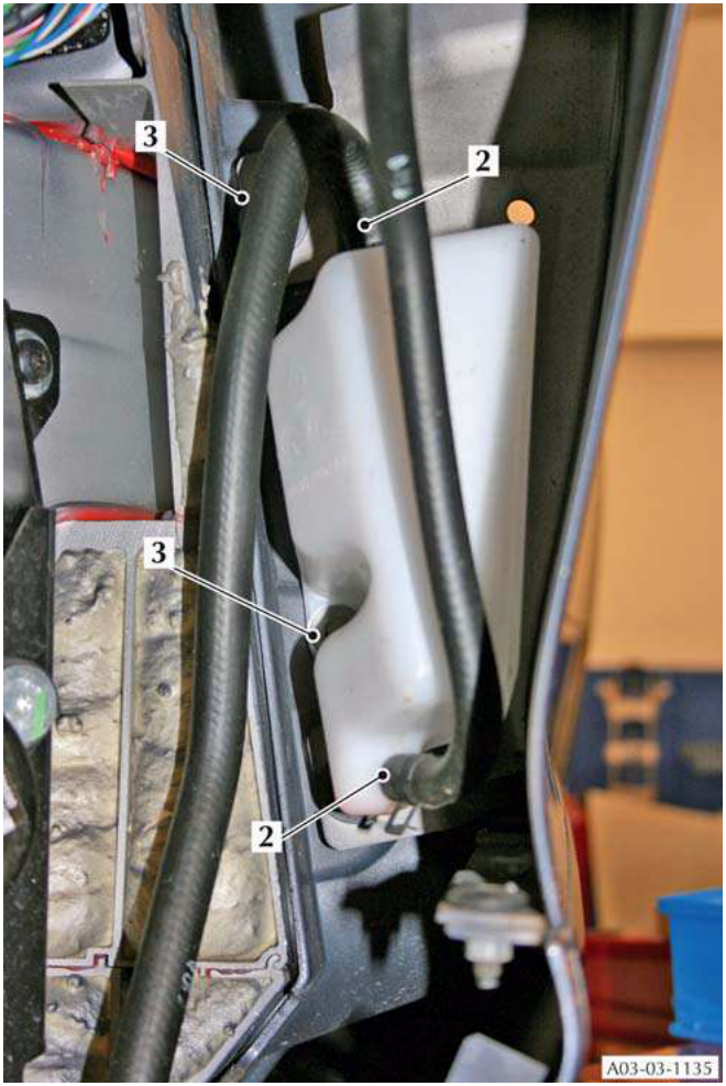Coolant recovery tank with hoses attached