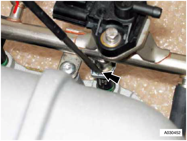 Injector to rail clips with arrow pointing to bolt