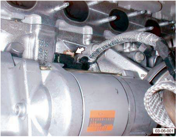Starter motor with disconnected solenoid multiplug and battery cable.