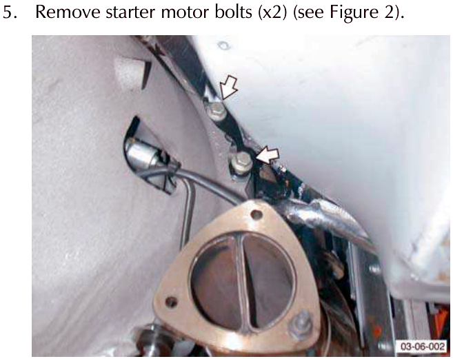 Close-up of starter motor bolts being removed.