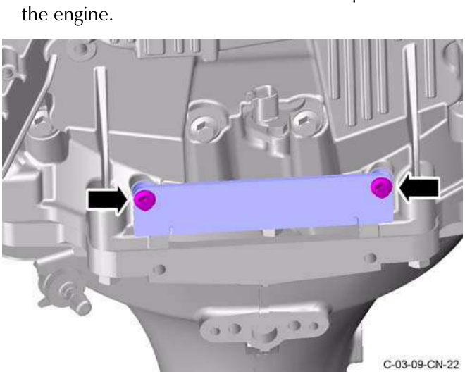Engine with special tool attached to flywheel, showing two screws being removed.