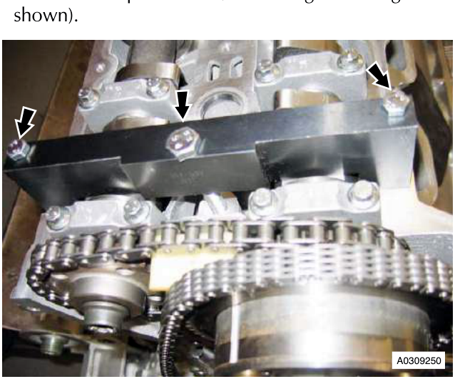 Engine component with chain and sprocket, arrows pointing to bolts