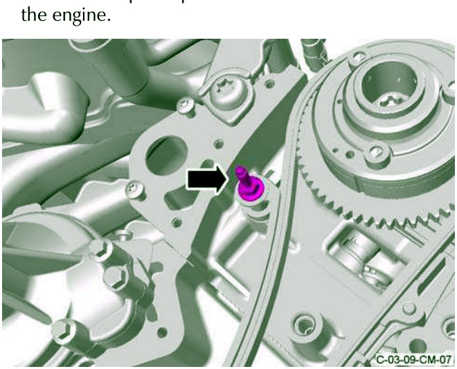 Close-up of engine showing special pivot bolt for tensioner arm being removed