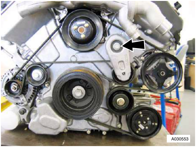 Engine with belt tensioner and pulleys, arrow pointing to M10 bolt