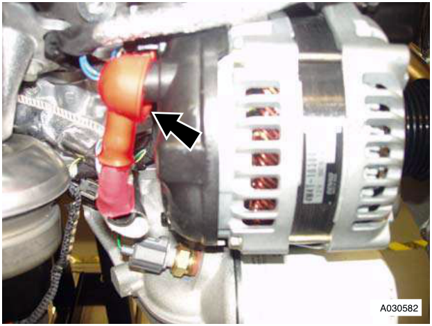 Alternator with red battery cable connector, arrow pointing to nut