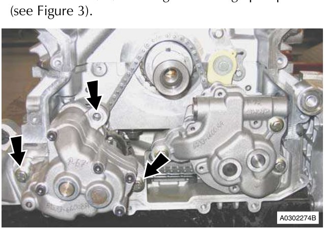 Engine block showing bolts securing oil scavenge pump to sump with arrows pointing to them