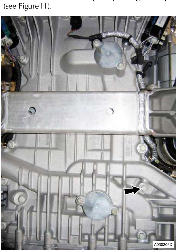 Arrow points to bolt on engine block for removal or installation