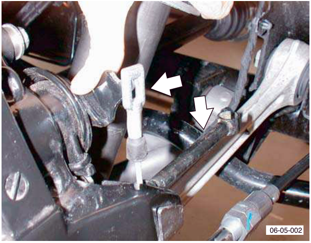 Handbrake cable removal with special tool compressing ring clip