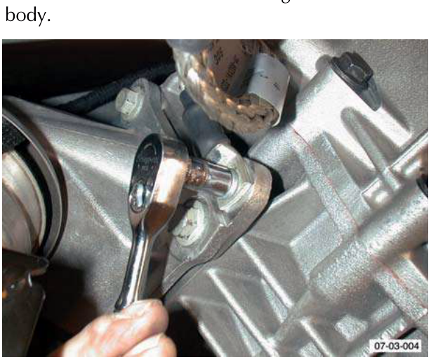 Ground cable nut being removed with wrench