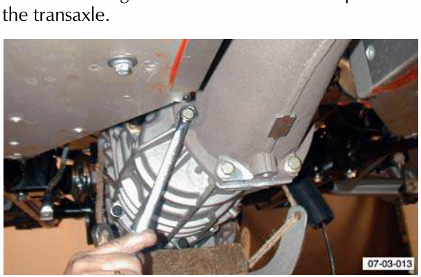 Torque tube bolts being removed from the transaxle
