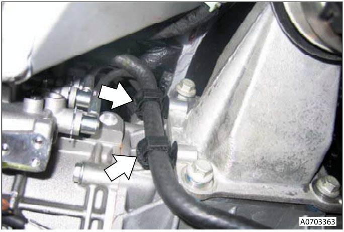 Reservoir hoses connected to transaxle mounting clips