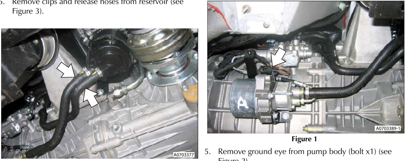 View of hydraulic reservoir hoses being released from clips near the transaxle.