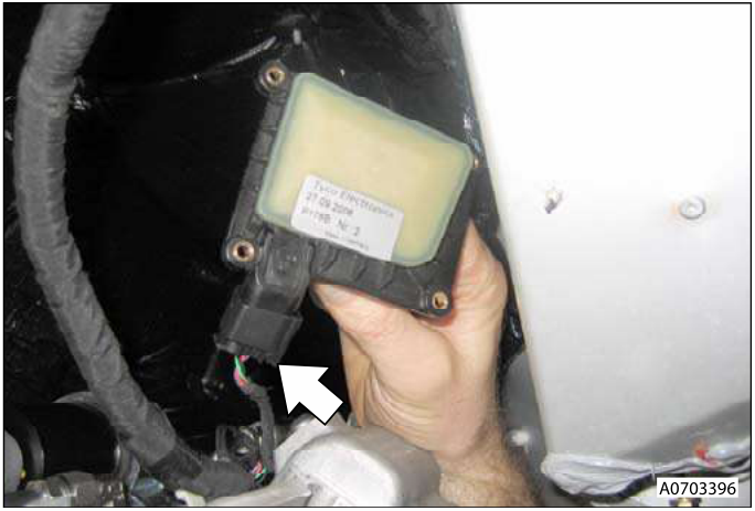 A hand holding a gear position sensor with wires connected to a multiplug. The sensor is black with a greenish-yellow label.