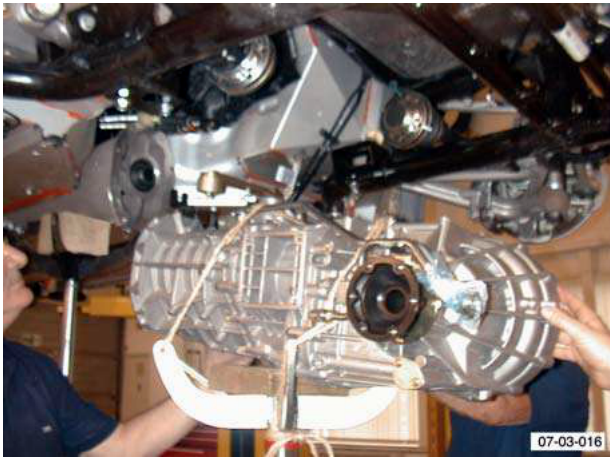 Transaxle being lowered with jack