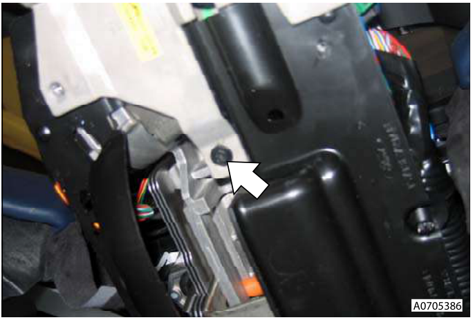 Close-up of paddle shift switch assembly with arrow pointing to electrical connector