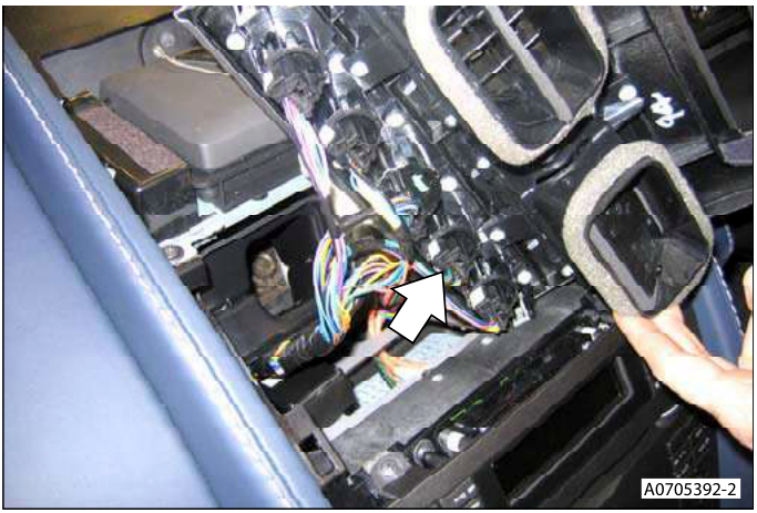 Interior view showing the Neutral 'N' switch multiplug being disconnected from the upper centre panel.