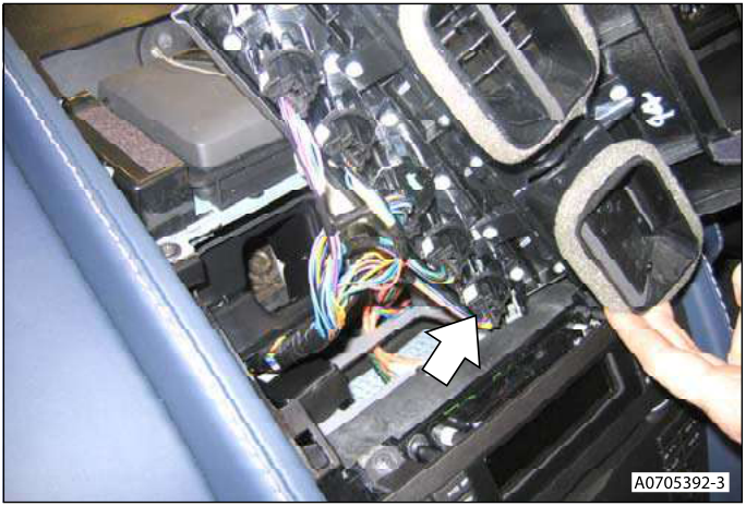 Interior view showing the Drive 'D' switch multiplug being disconnected from the upper centre panel.