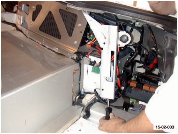 Power socket bracket and amplifier bracket with wiring visible, hands working on the components.