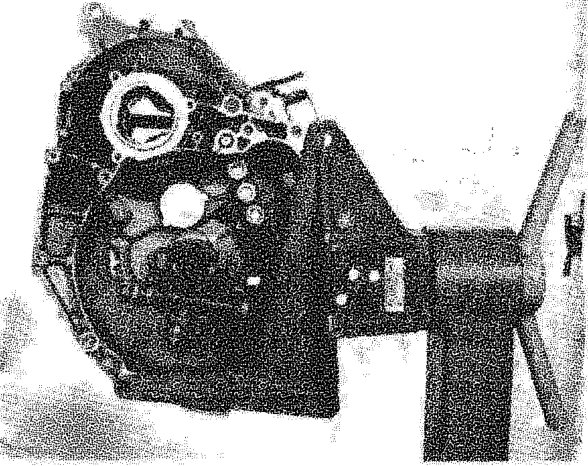 A gearbox mounted on a rotating stand for dismantling operations.