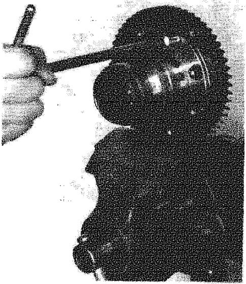 Mechanic using a tool to remove the crown wheel from the differential casing