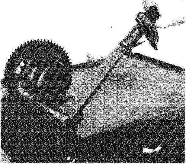 Photograph showing a crown wheel being fitted onto a differential casing using a tool to align it.
