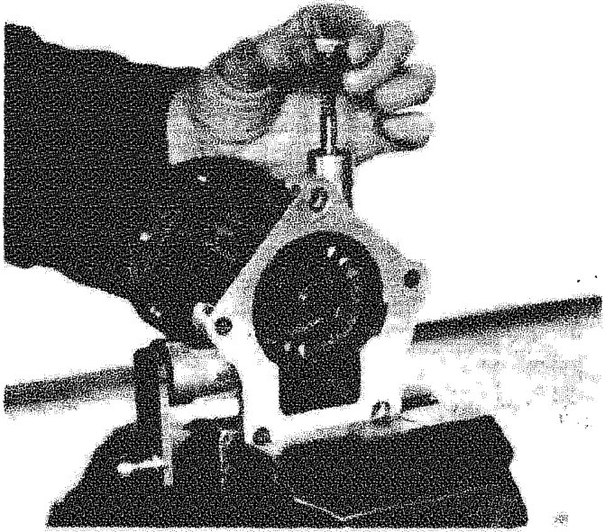 Hand removing the rear transmission clutch selector pawl from its housing