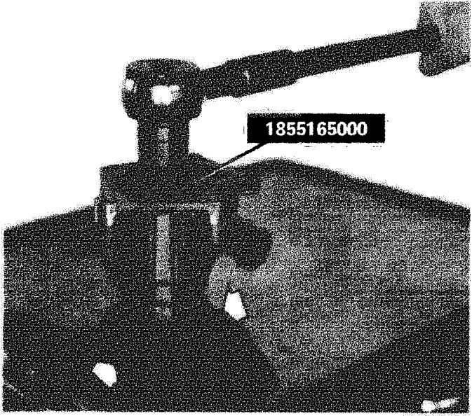 Tool 1855165000 being used to remove a ring nut fixing the output shaft for rear drive