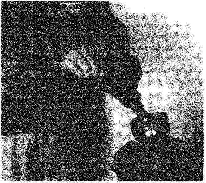A close-up of hands working on a constant velocity joint boot on a drive shaft