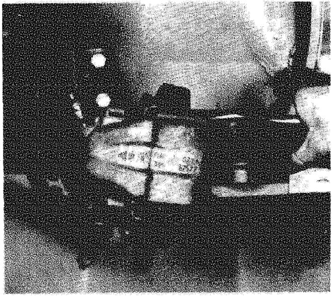 View of the brake pads being removed or refitted within the caliper housing