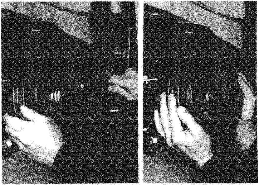 Two hands removing a brake drum from the rear wheel hub assembly