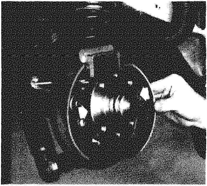 A hand removing or refitting a brake shoe from the hub