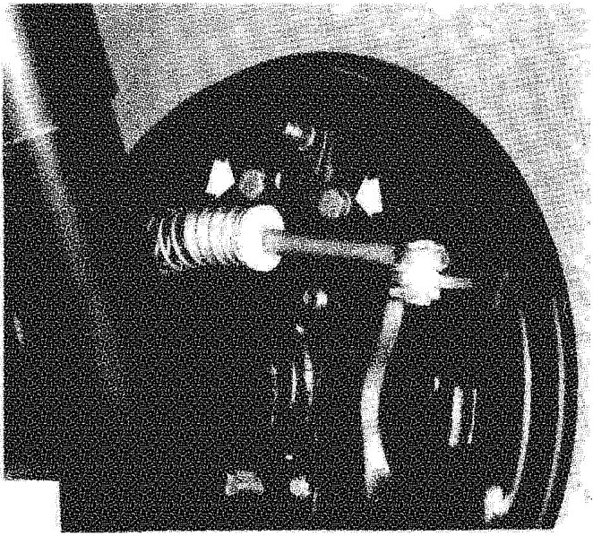 Wheel cylinder removed from backing plate with return springs visible