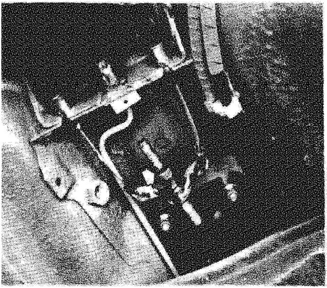 Photograph showing the internal handbrake adjustment mechanism located under the vehicle floor panel.