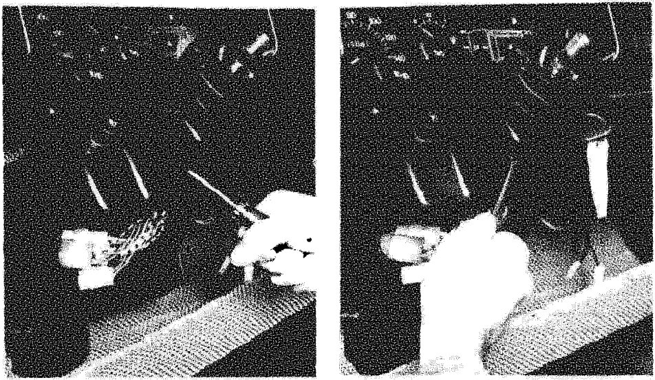 Hands using a tool to remove the steering column switch unit from under the dashboard